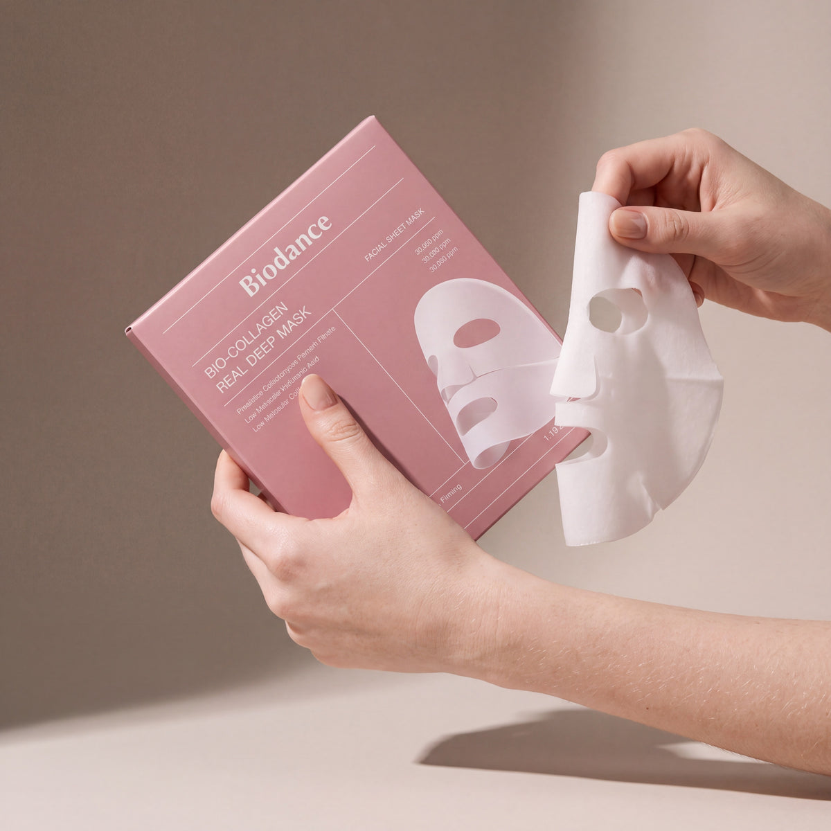 Biodance Bio-Collagen Real Deep Mask 4pcs held in hands, editorial studio shot