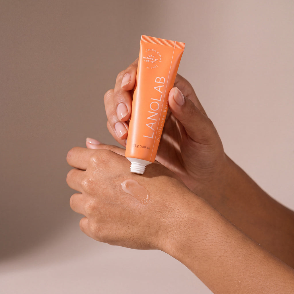 Lanolab Multi-Use Balm held in hands, editorial studio shot