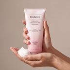 Biodance Collagen Mask to Foam Cleanser held in hands, editorial studio shot