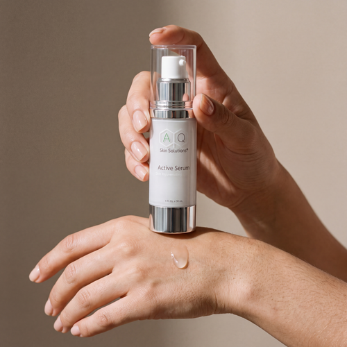 AQ Active Serum held in hands, editorial studio shot