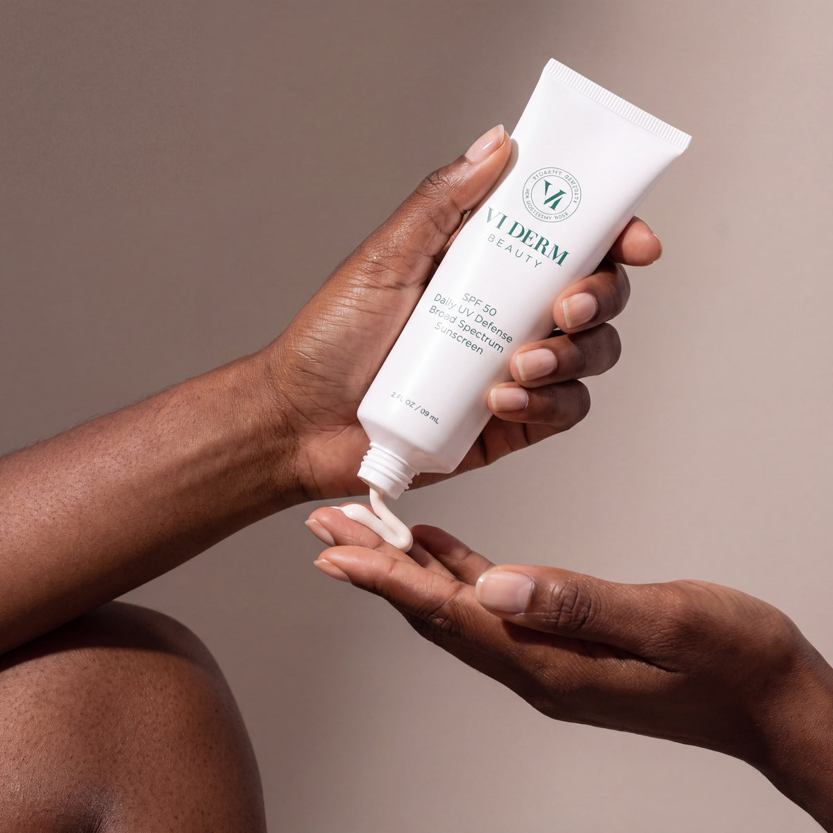 VI DERM Daily UV Defense Broad Spectrum Defense held in hands, editorial studio shot