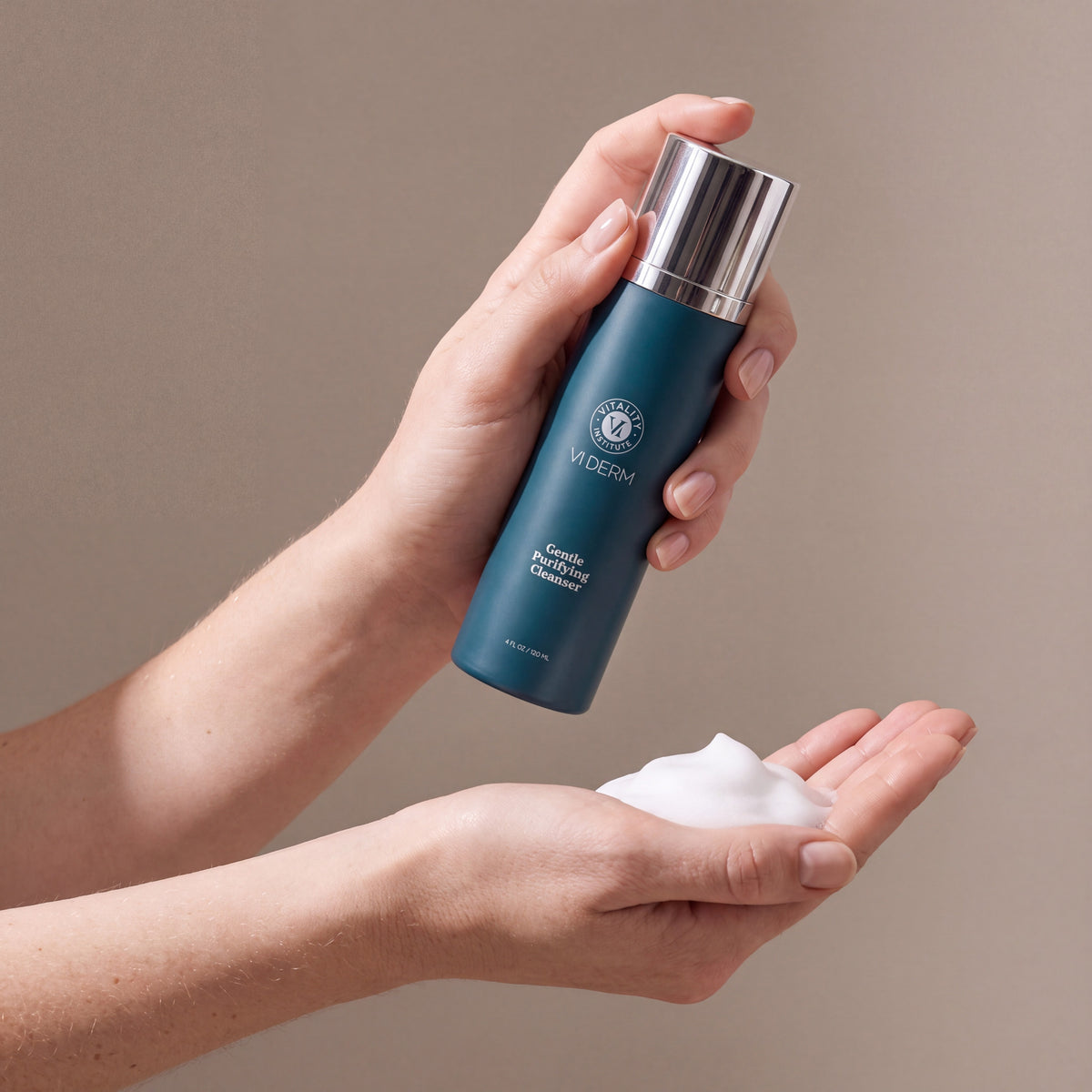 VI DERM Gentle Purifying Cleanser held in hands, editorial studio shot