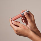 Colorescience Peptide Lip Shine SPF 30 – Savanna held in hands, editorial studio shot