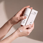 ULA Skin Barrier Repair Cream held in hands, editorial studio shot