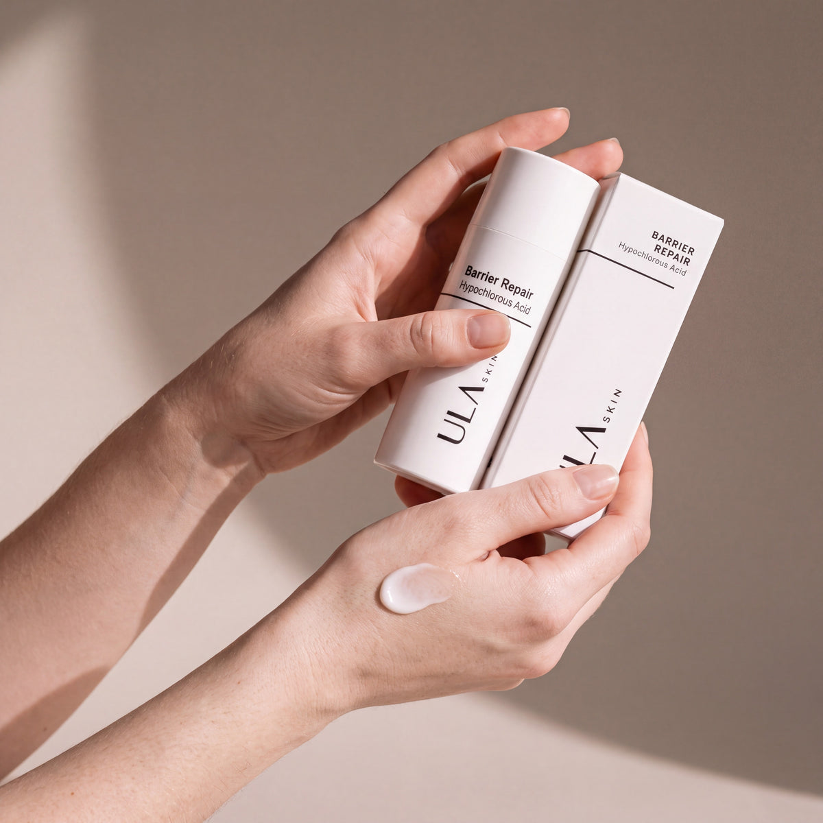 ULA Skin Barrier Repair Cream held in hands, editorial studio shot