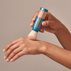 Colorescience Sunforgettable® Total Protection™ Brush-On Shield SPF 50 – Bronze held in hands, editorial studio shot