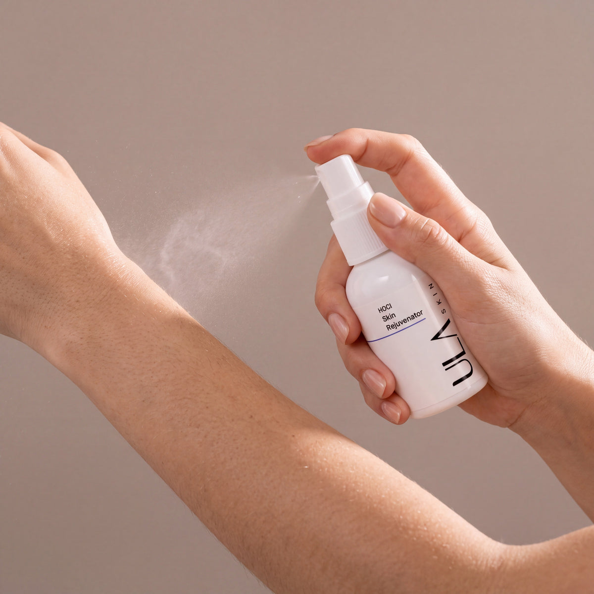 ULA Skin Rejuvenator Hypochlorous Acid 50ml held in hands, editorial studio shot