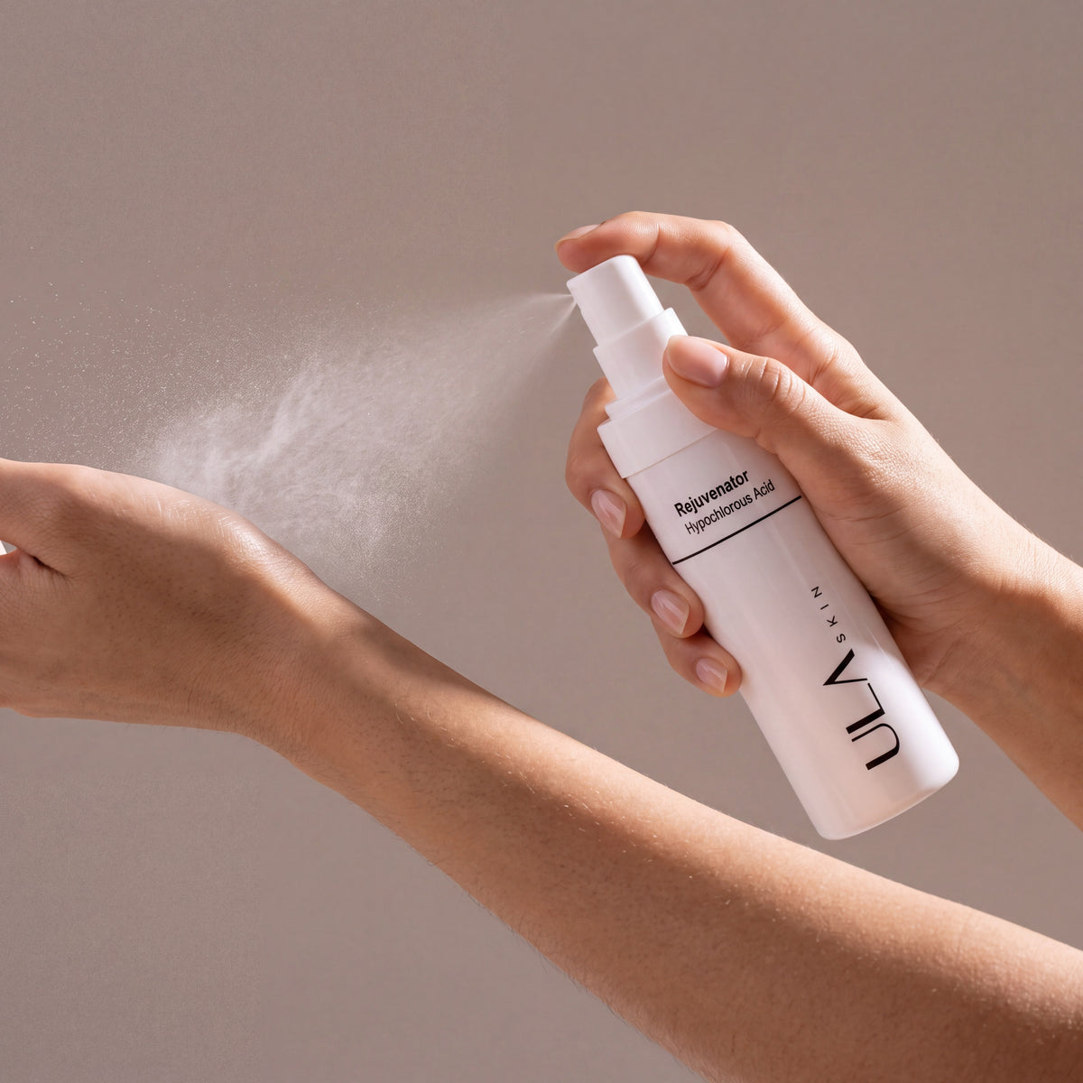 ULA Skin Rejuvenator Hypochlorous Acid Spray 125ml held in hands, editorial studio shot
