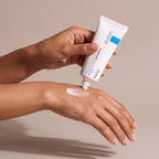 La Roche Posay Cicaplast Baume B5+ held in hands, editorial studio shot