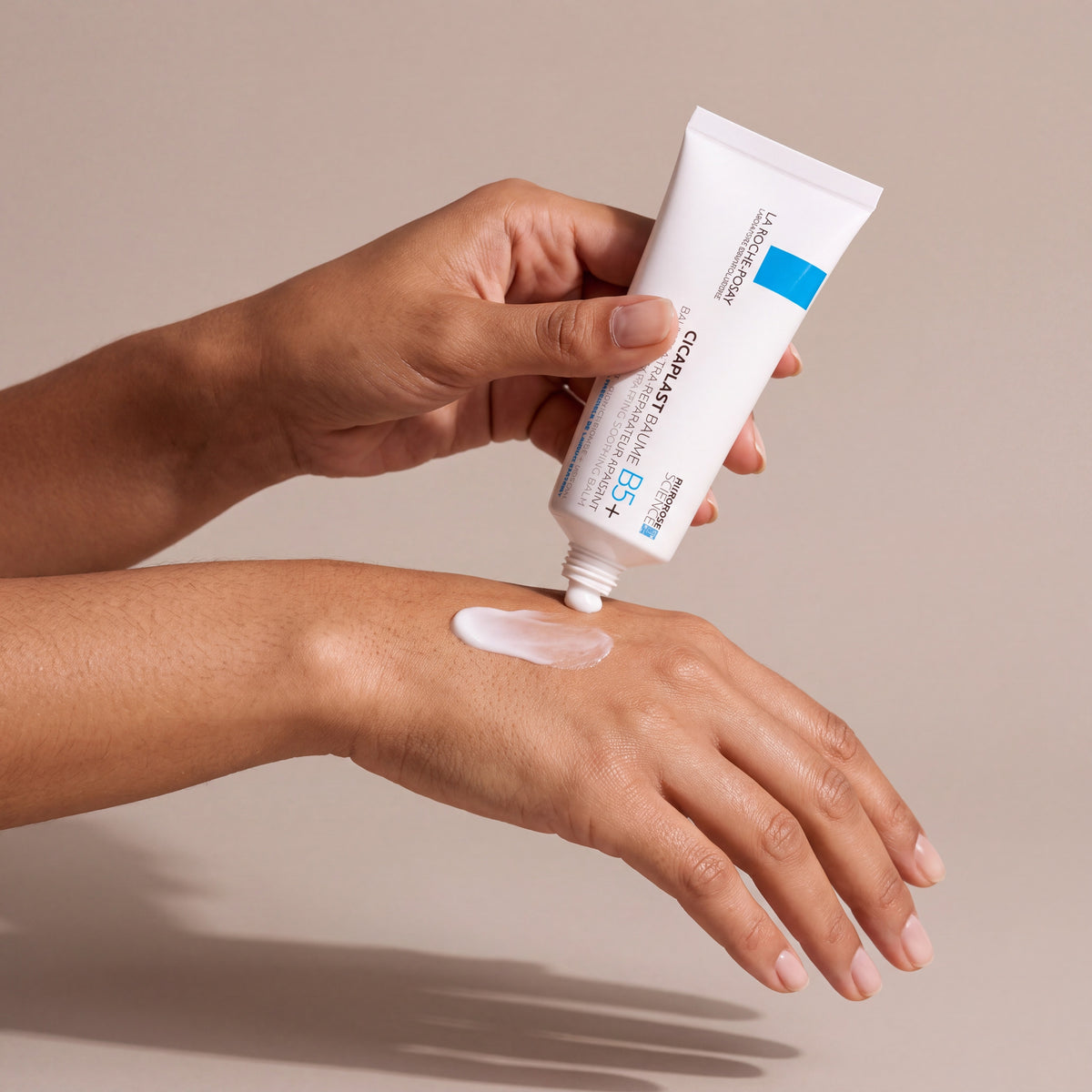 La Roche Posay Cicaplast Baume B5+ held in hands, editorial studio shot
