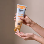 Isdin Gel Cream SPF 50 held in hands, editorial studio shot