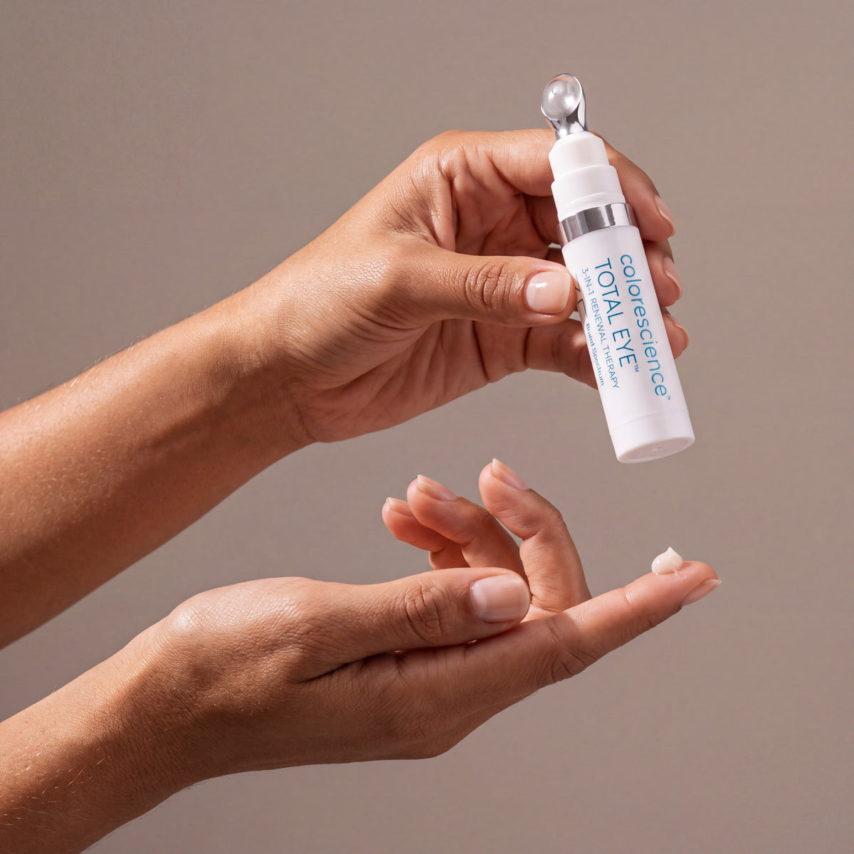 Colorescience Total Eye 3-in-1 Renewal Therapy SPF 35 held in hands, editorial studio shot