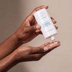 Colorescience No-show Mineral Sunscreen held in hands, editorial studio shot