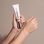 Decoded Treatment Foundation no 2 held in hands, editorial studio shot