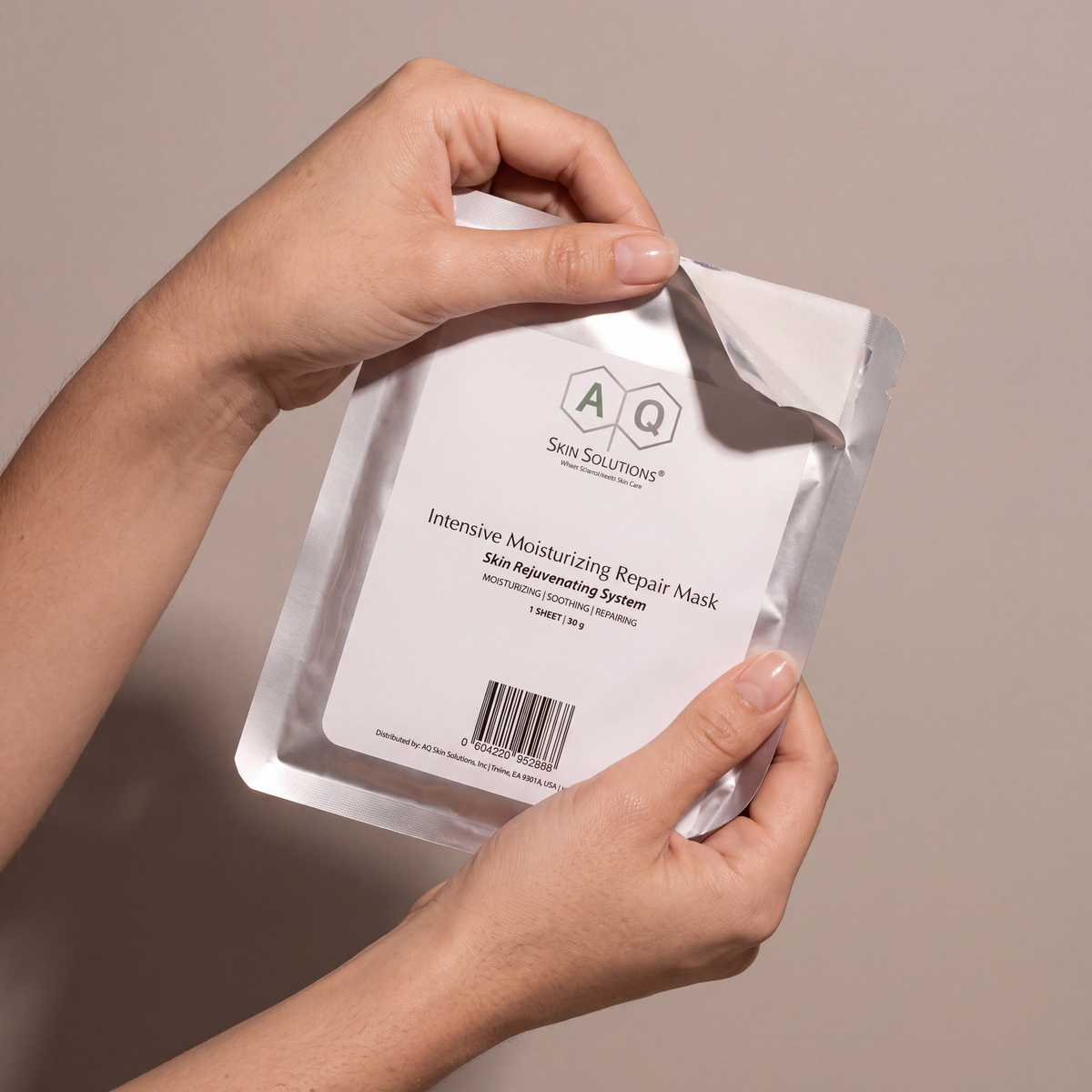 AQ Moisturising & Repair Mask held in hands, editorial studio shot