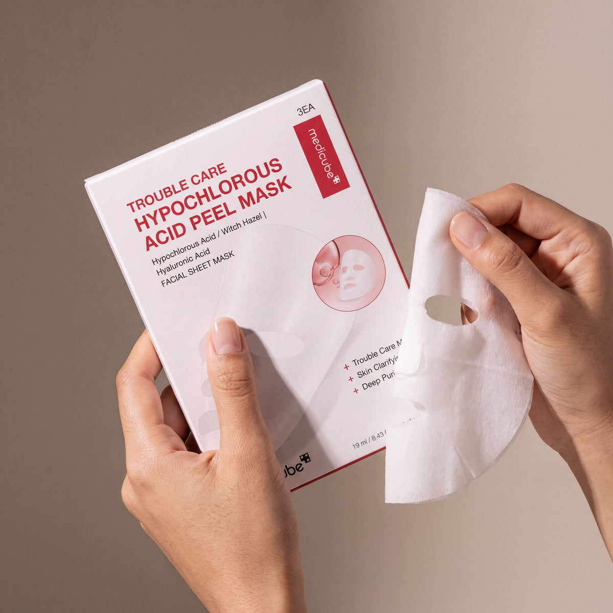 Medicube Hypochlorous Acid Peel Mask held in hands, editorial studio shot