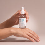 SVR Ampoule Hydra held in hands, editorial studio shot