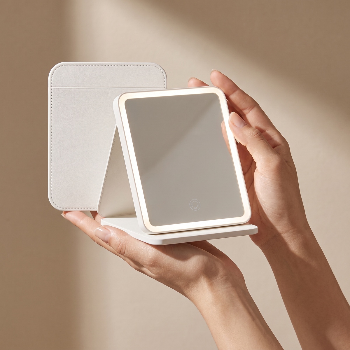 Portable LED Leather Foldable Makeup Mirror held in hands, editorial studio shot