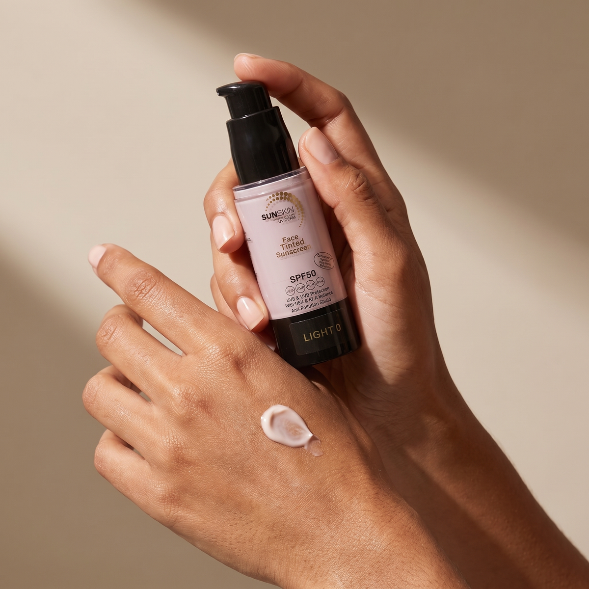 SUNSKIN Tinted Face Sunscreen SPF50 held in hands, editorial studio shot